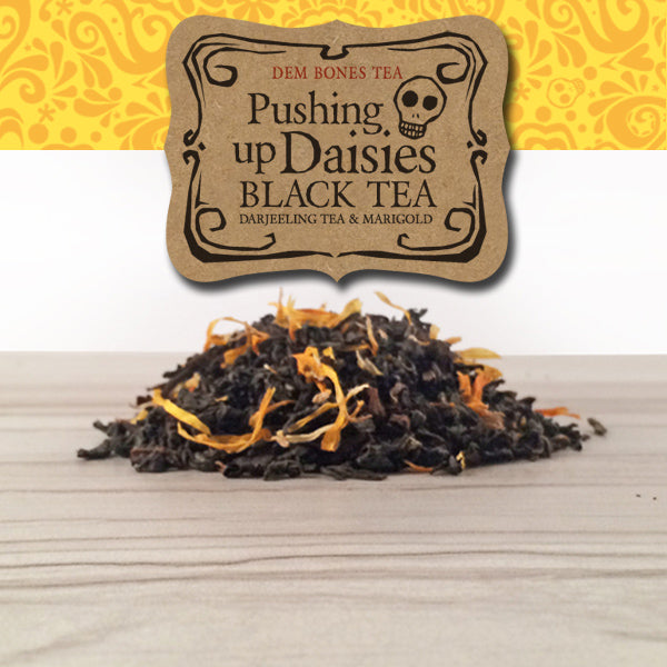 Pile of Tea on Tile background, Yellow graphics band with kraft label, Dem Bones Tea, Pushing Up Daisies, Black tea, Darjeeling Tea and Marigold, 