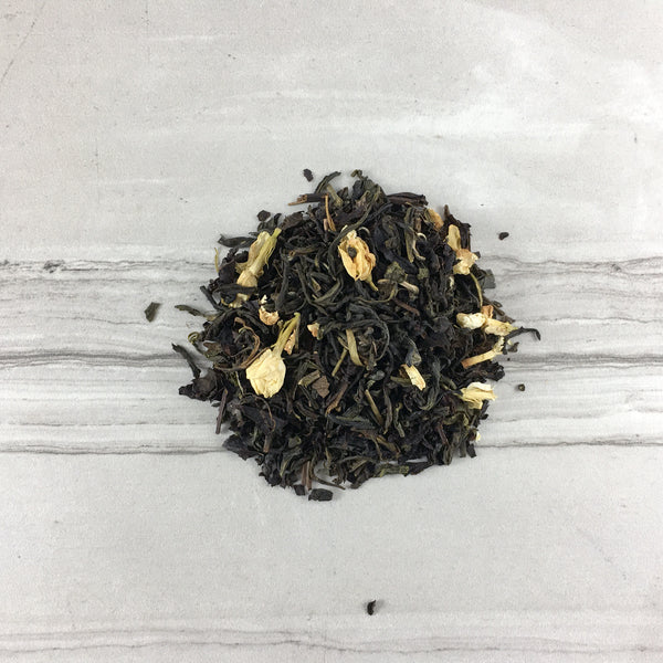 Small pile of DemBones  Jasmine Green Tea, Light tile background, Gothic Tea Rituals