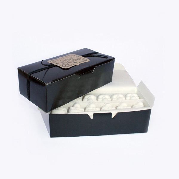 Stacked Black Candy Boxes, Skull Sugar Cubes in bottom box, white background