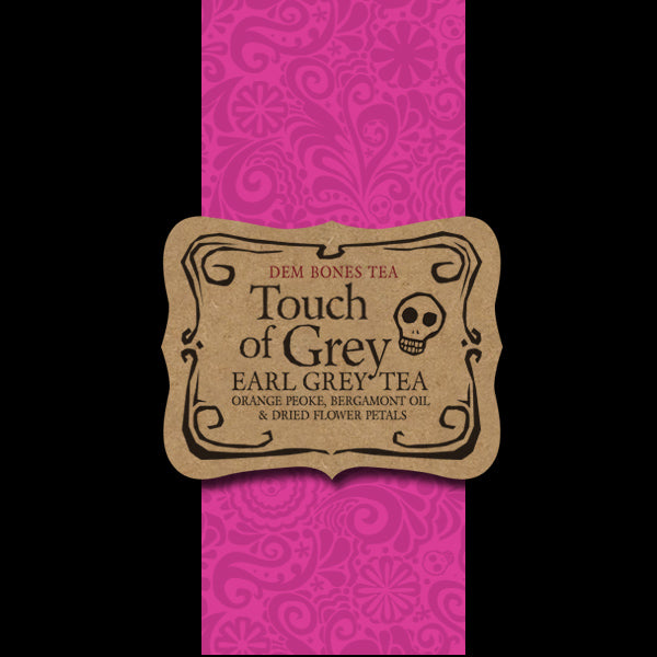 Black Background, Pink graphics band, Kraft Label with text, Dem Bones, Tough of Grey Tea, Earl Grey Tea, Orange Peoke, Bergamont Oil, Dried Flower Petals 