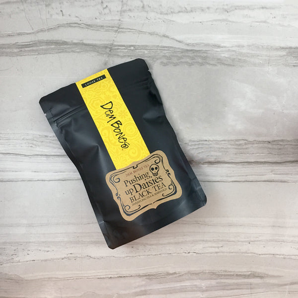 DemBones Tea in black bag with yellow band and kraft label,  Pushing up Daisies Black Tea, Darjeeling Tea and Marigold, Gothic Tea