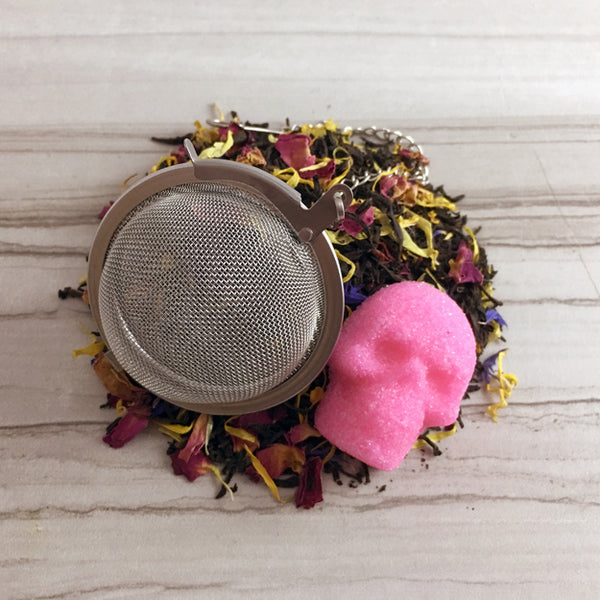 Earl Grey Tea,  Tea ball, Pink Sugar Skull, on light tile 